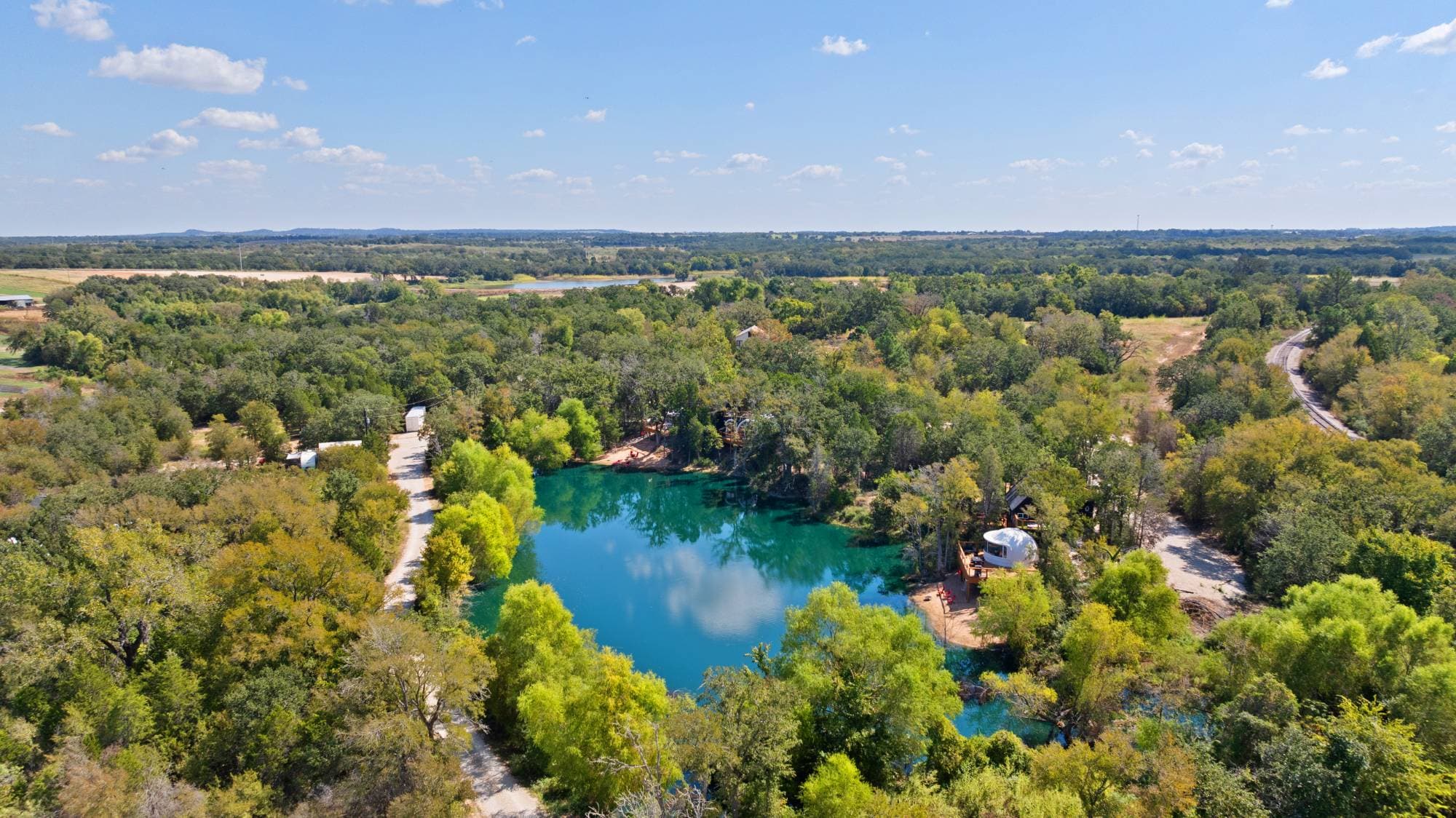 Aerial view of the Zenfulcove lagoon and glamping stays near Austin, Texas