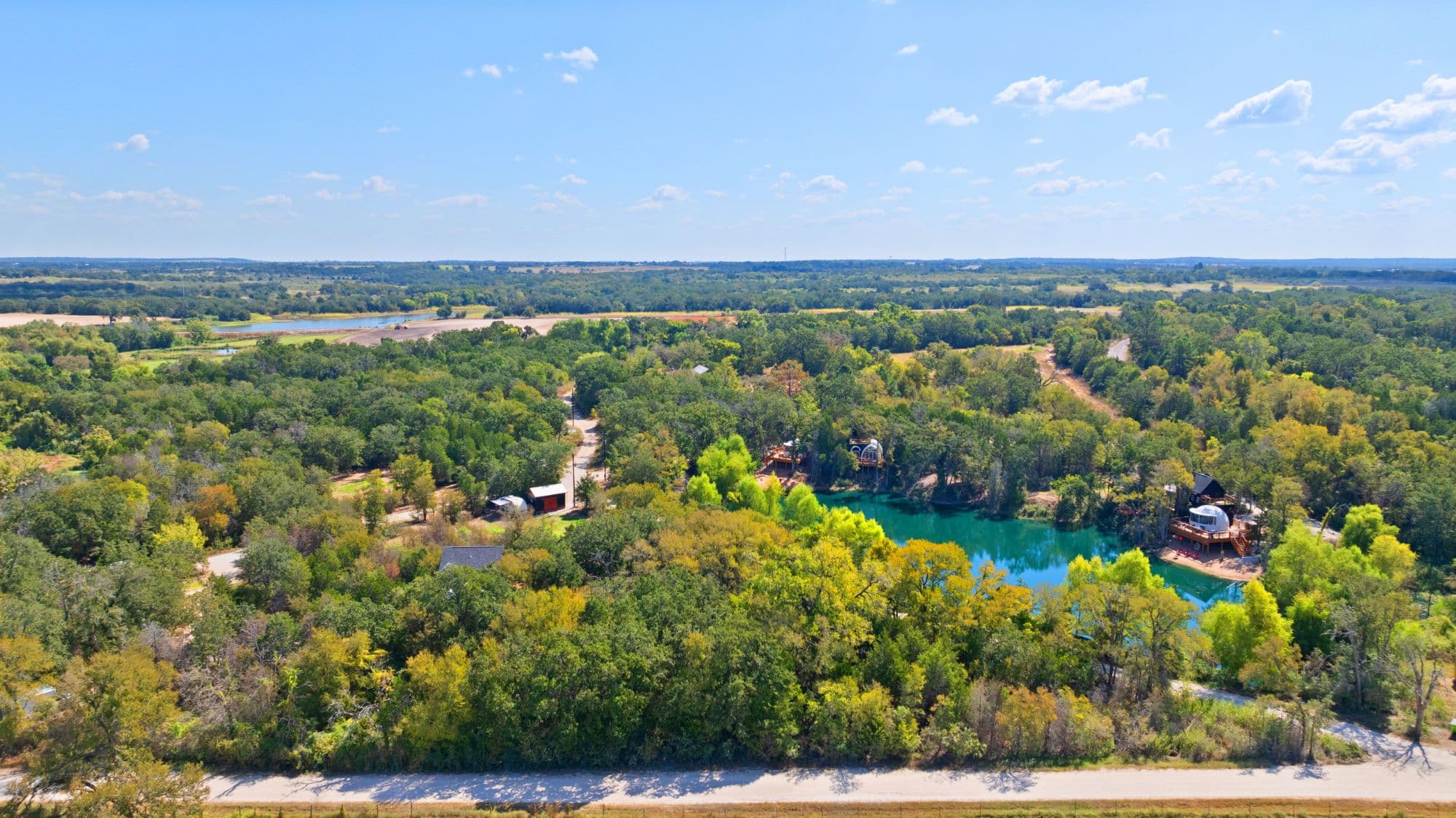 Aerial view of the wooded Zenfulcove glamping property in Elgin, Texas